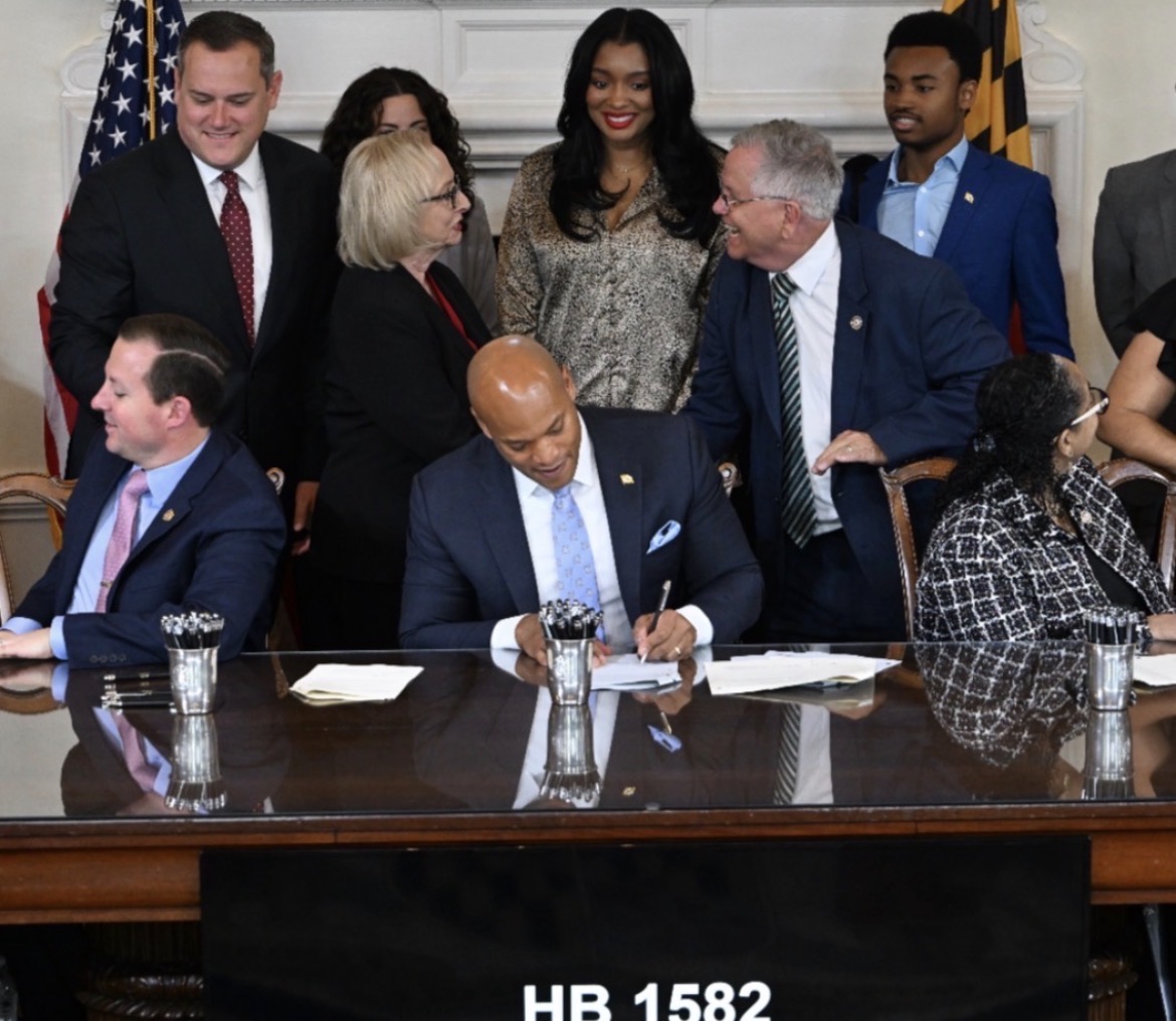 Governor Wes Moore signing HB 1582 with Yvonne Harper and Maryland legislators