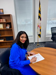 Yvonne Harper signing documents in her office