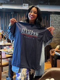 Yvonne Harper holding her District 10 campaign t-shirt